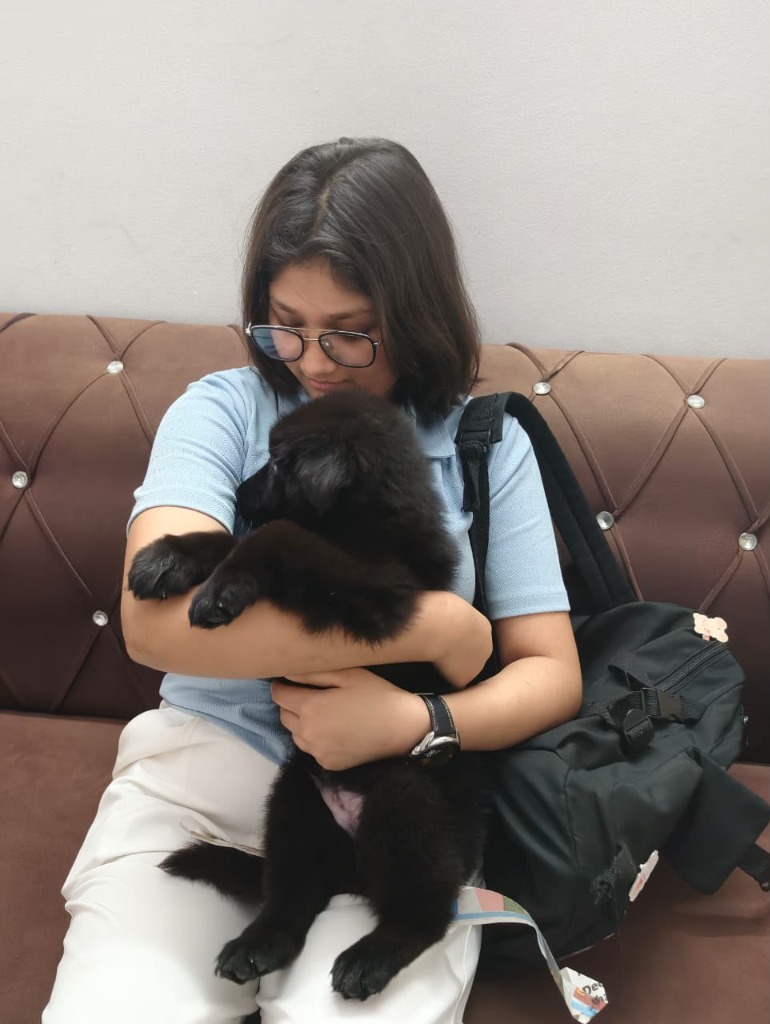 Ananya Iyer with their Black German Shepherd